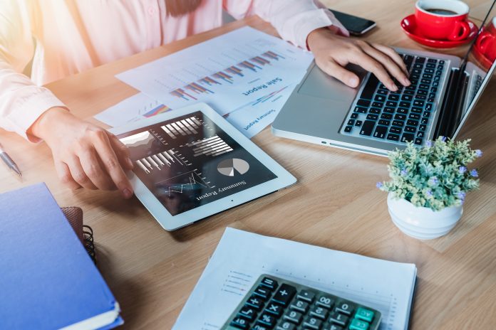 Business woman working with digital tablet and book and document